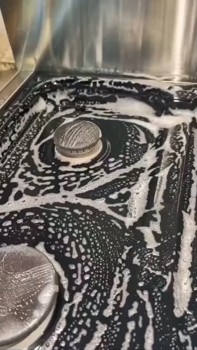 A thorough cleaning pass around a stainless kitchen sink.